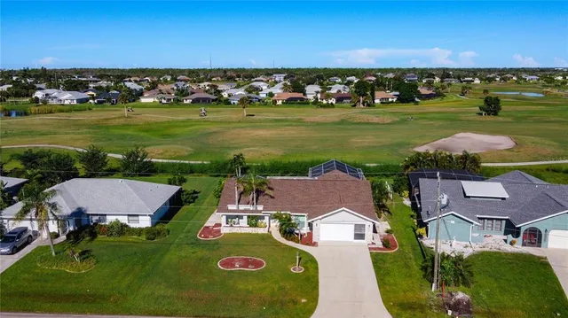 an aerial view of a house with a swimming pool yard and outdoor seating