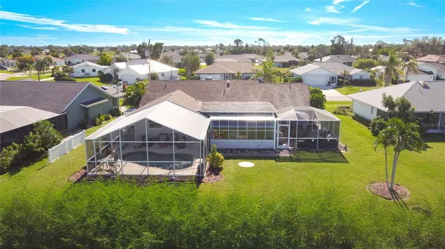 an aerial view of a house with yard swimming pool and ocean view