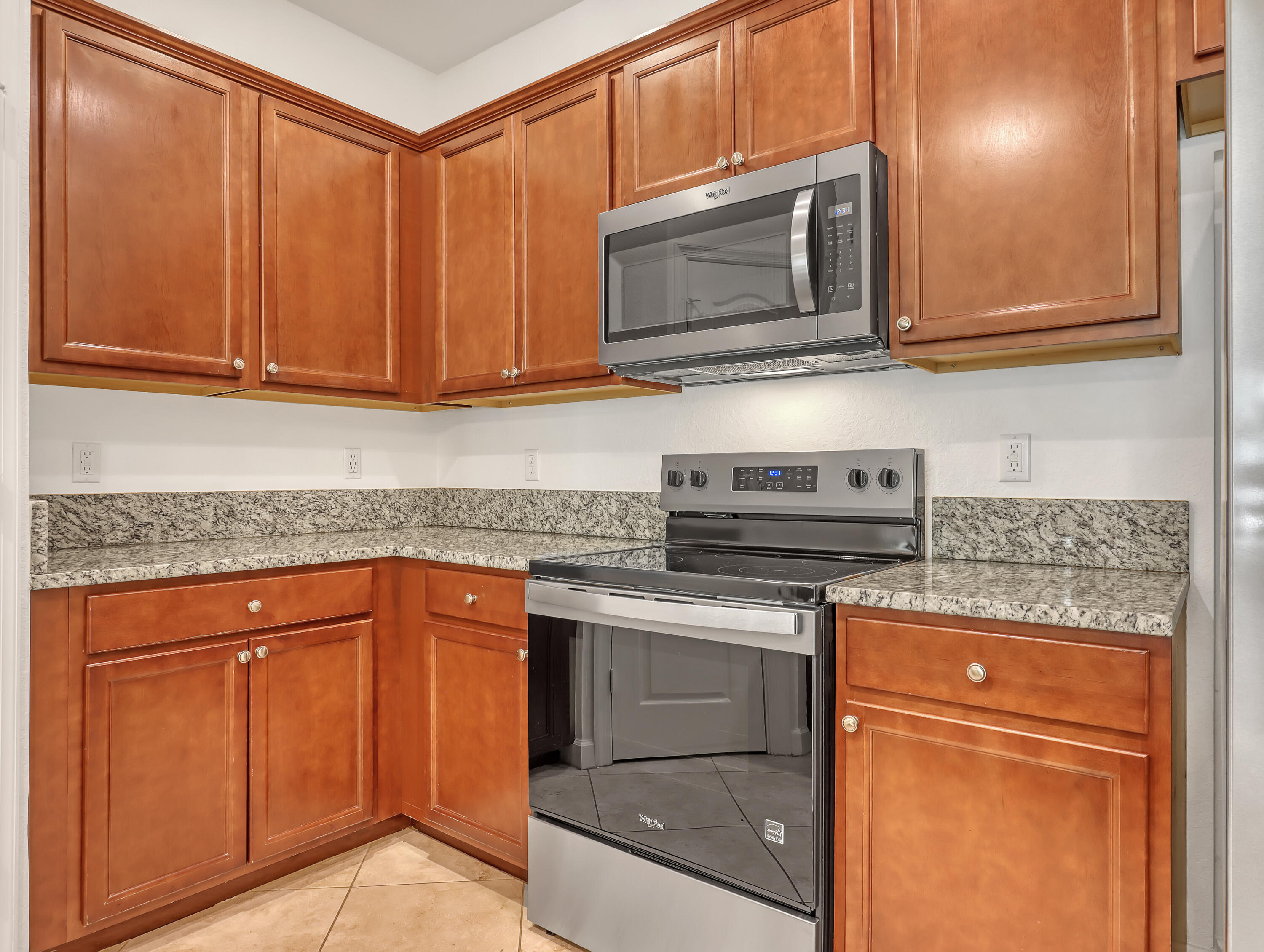9508 Southwest Otter Lane Stuart, FL 34997 - Photo 14 of 34 a kitchen with granite countertop cabinets stainless steel appliances and a sink