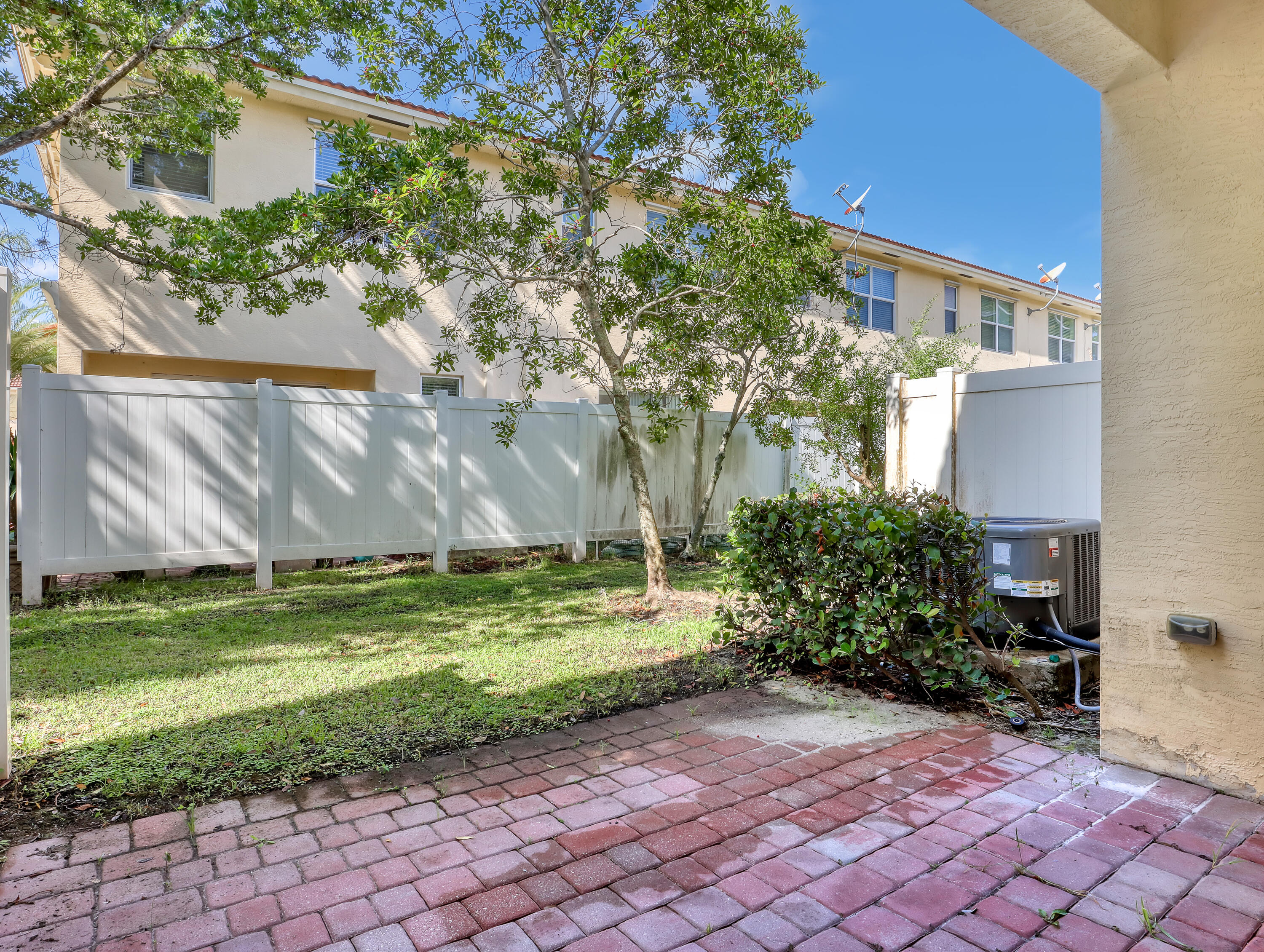 9508 Southwest Otter Lane Stuart, FL 34997 - Photo 30 of 34 a view of a backyard with plants and a large tree