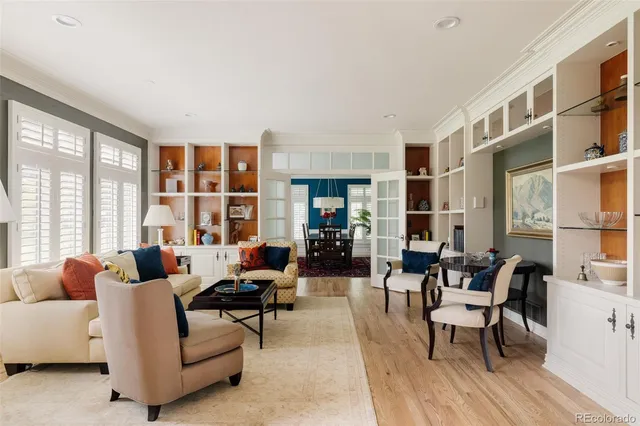 a living room with furniture and floor to ceiling windows