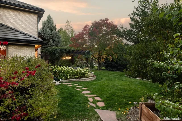 a view of a house with a big yard and potted plants
