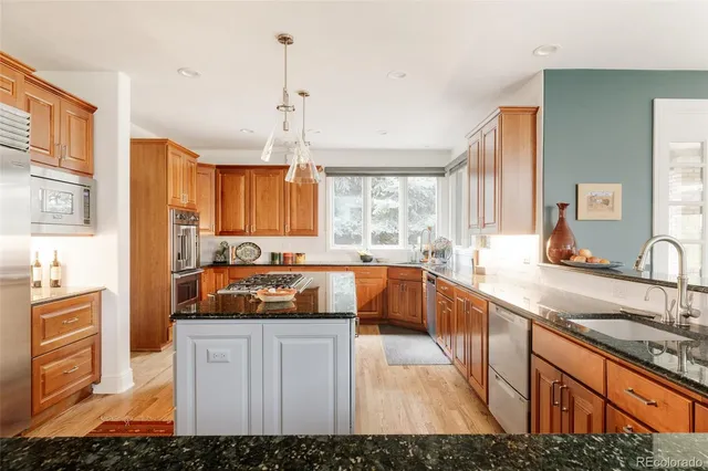 a kitchen with stainless steel appliances granite countertop a sink and cabinets