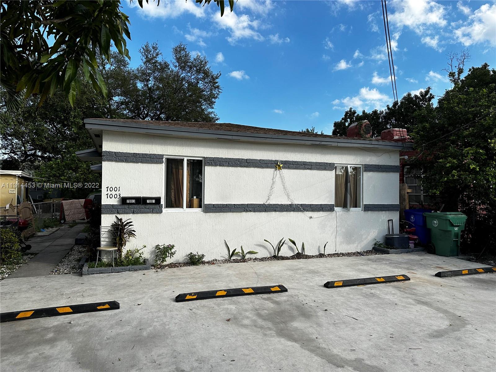 a view of a house with backyard sitting area and garden
