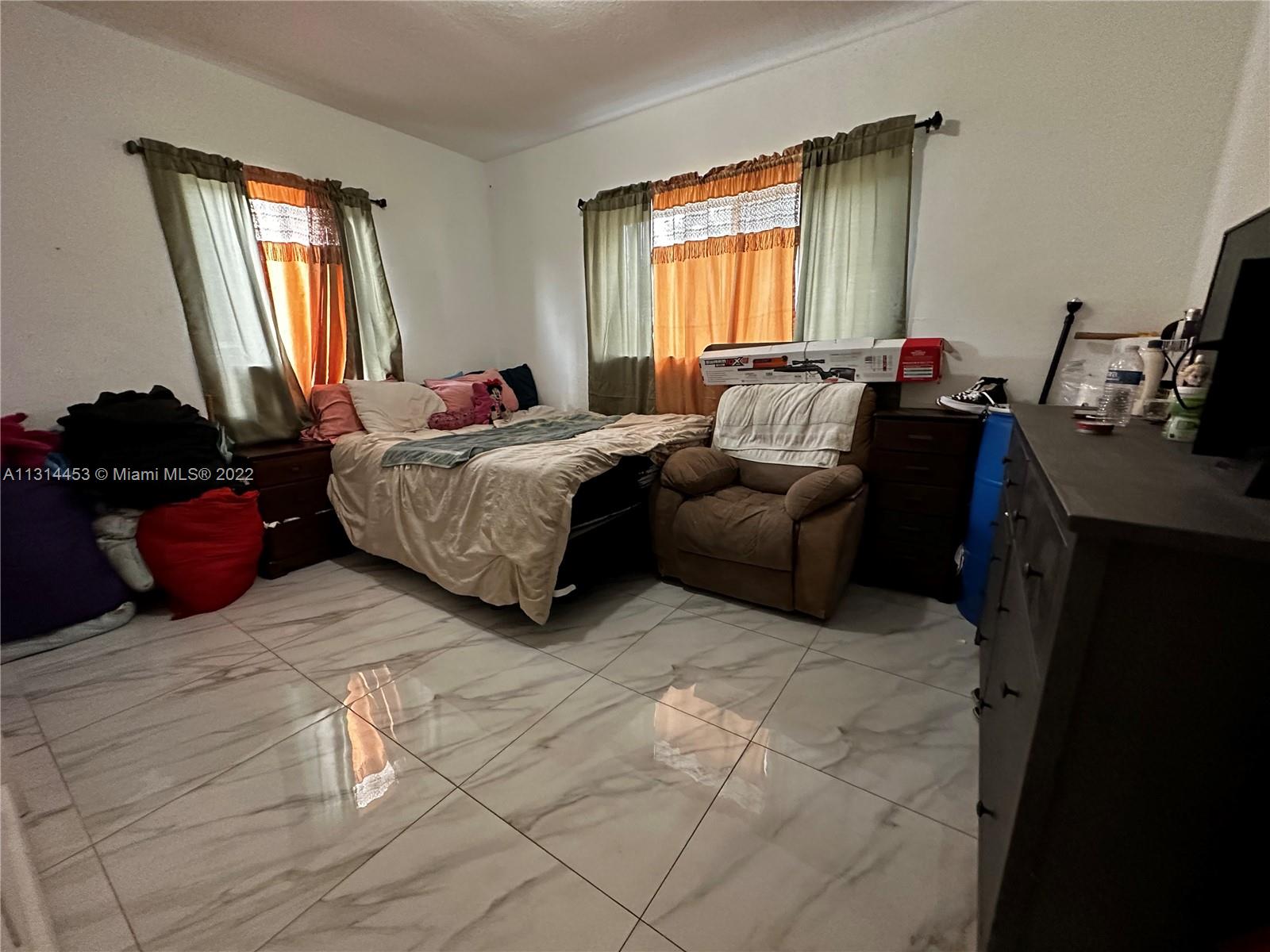 7001 Northwest 6th Avenue Miami, FL 33150 - Photo 5 of 7 a bed room with a bed and a window