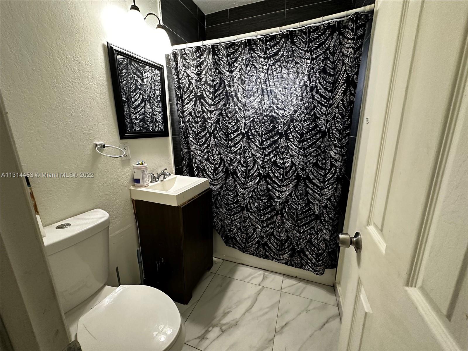 7001 Northwest 6th Avenue Miami, FL 33150 - Photo 7 of 7 a bathroom with a sink and toilet