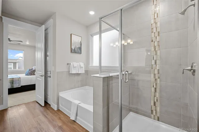 a bathroom with a tub shower and sink