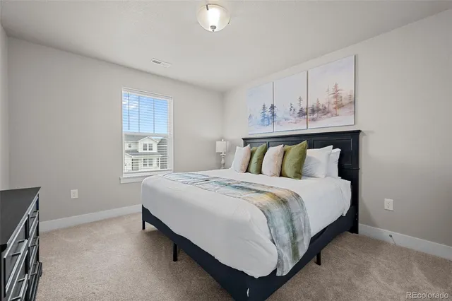 a bed sitting in a bedroom next to a window