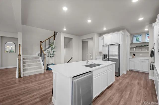 a kitchen with stainless steel appliances a white stove top oven and a refrigerator