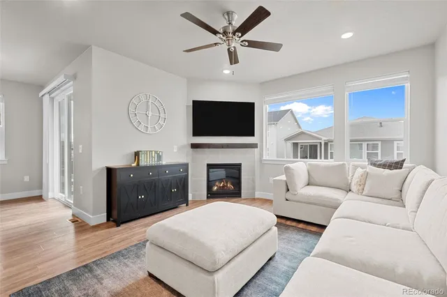 a living room with furniture a fireplace and a flat screen tv