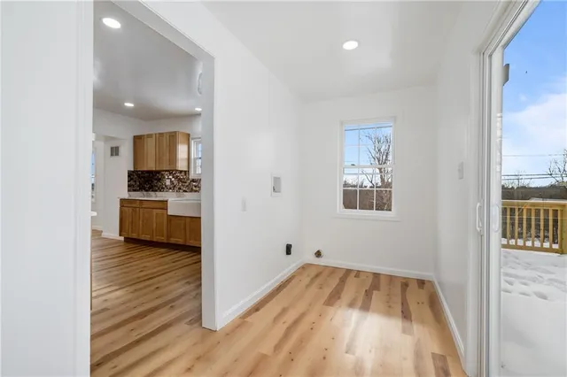 a view of kitchen with sink and wooden floor