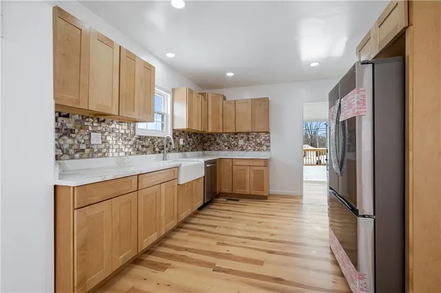 a kitchen with stainless steel appliances granite countertop a refrigerator sink and cabinets