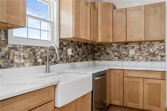 a kitchen with stainless steel appliances granite countertop a sink and a white cabinets