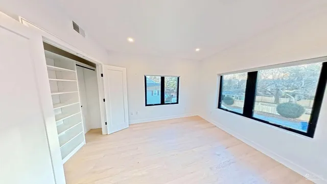 a view of an empty room with large window