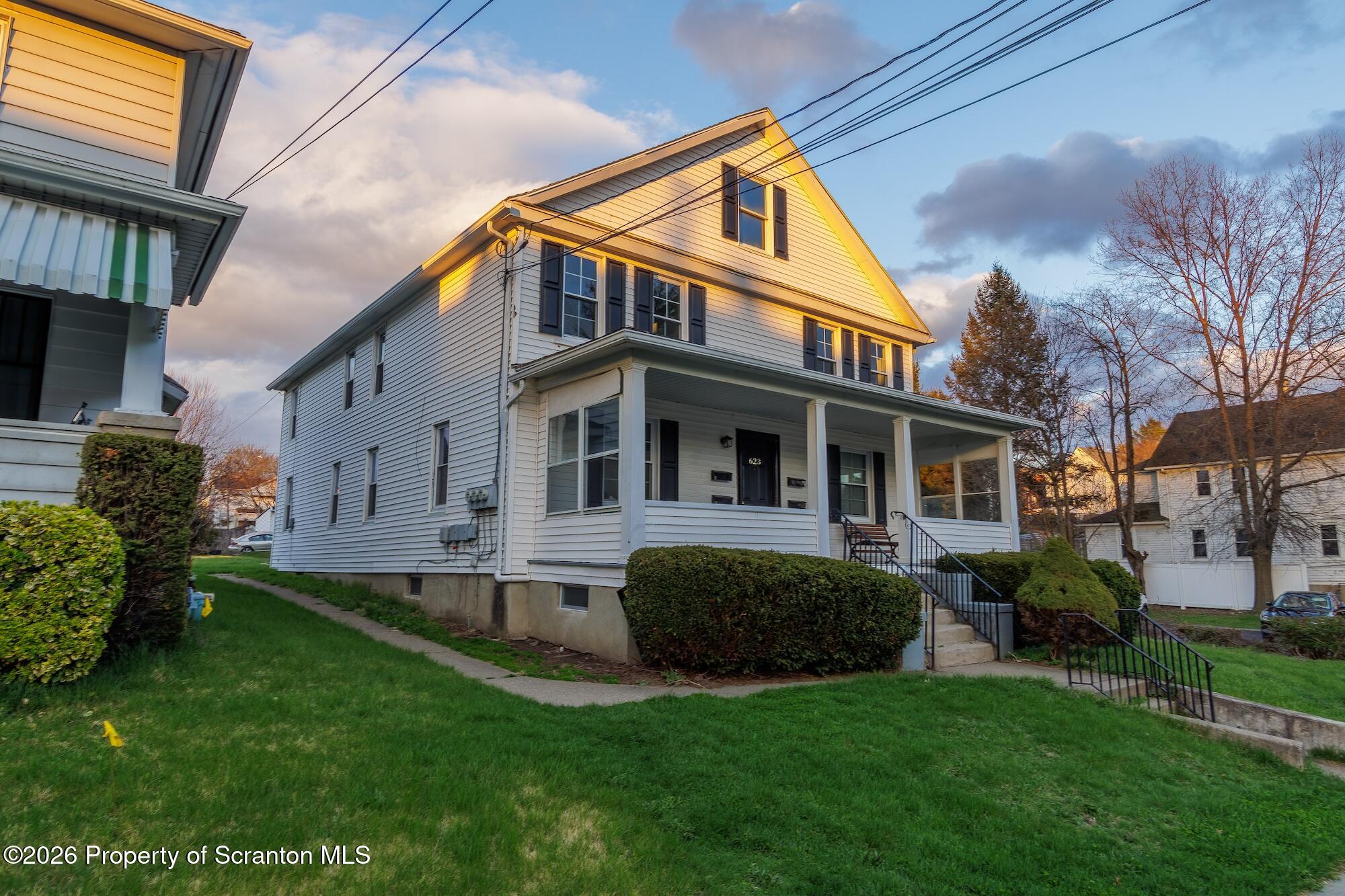 623 East Elm Street, Unit 3 Scranton, PA 18505 - Photo 1 of 18 a front view of a house with a garden
