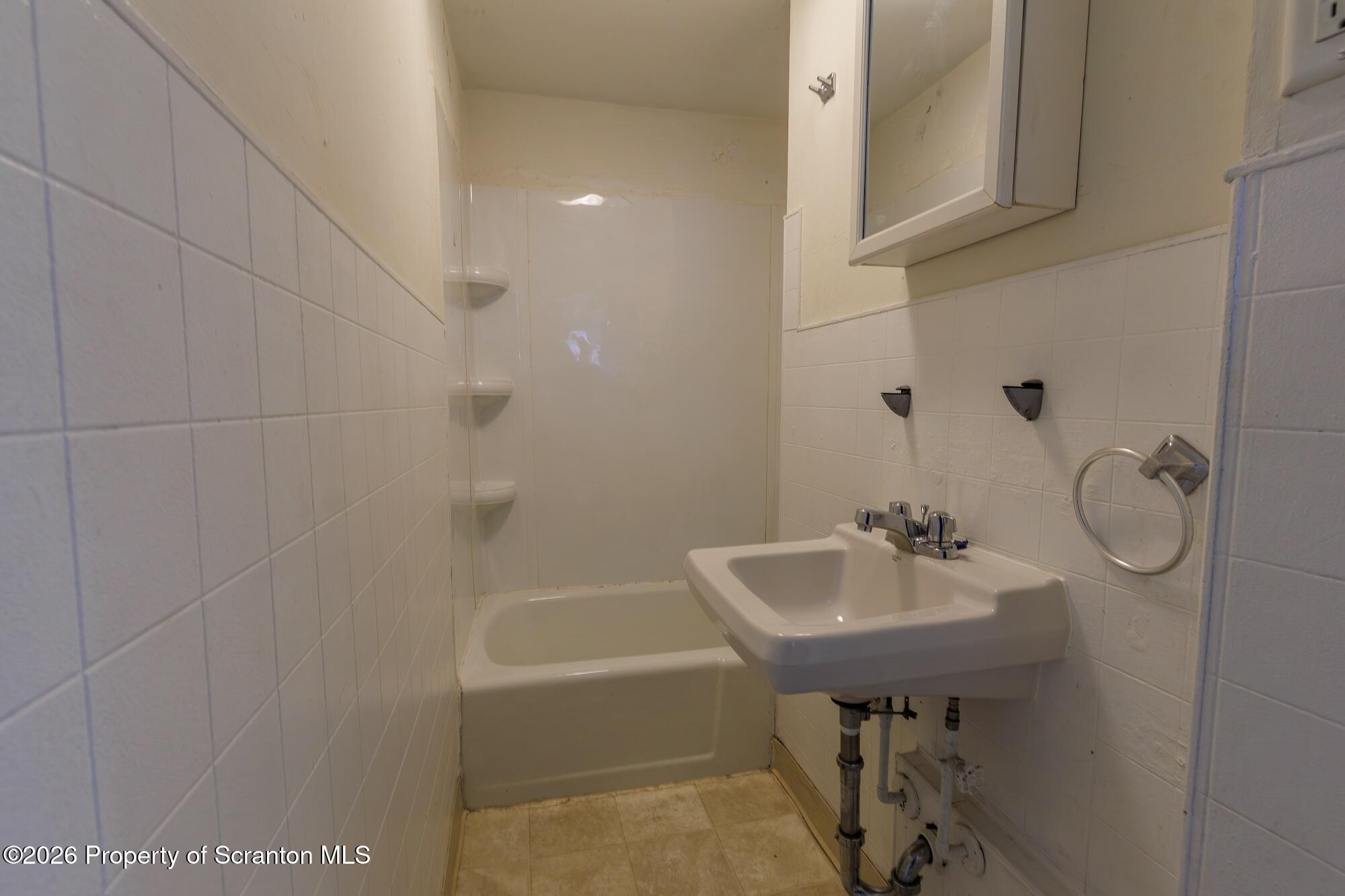 623 East Elm Street, Unit 3 Scranton, PA 18505 - Photo 12 of 18 a bathroom with a sink a toilet and shower