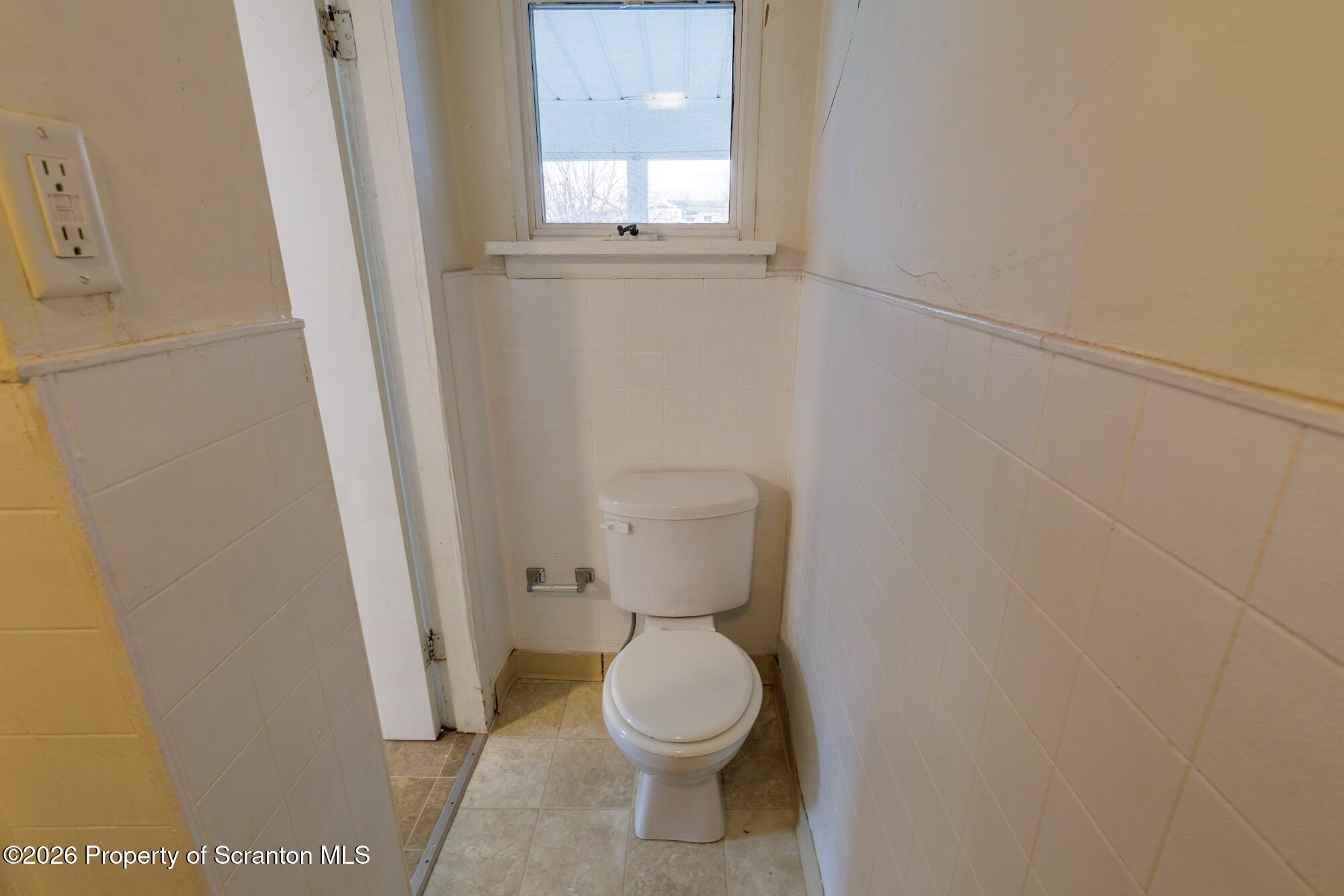 623 East Elm Street, Unit 3 Scranton, PA 18505 - Photo 13 of 18 a white toilet sitting in a bathroom next to a window