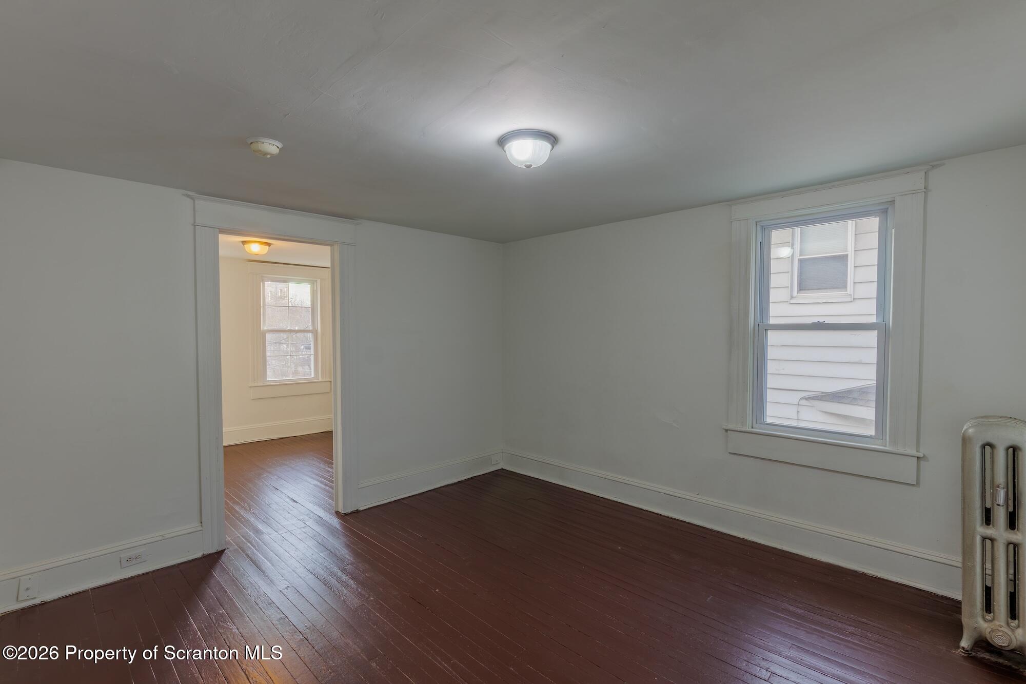 623 East Elm Street, Unit 3 Scranton, PA 18505 - Photo 4 of 18 an empty room with wooden floor and windows