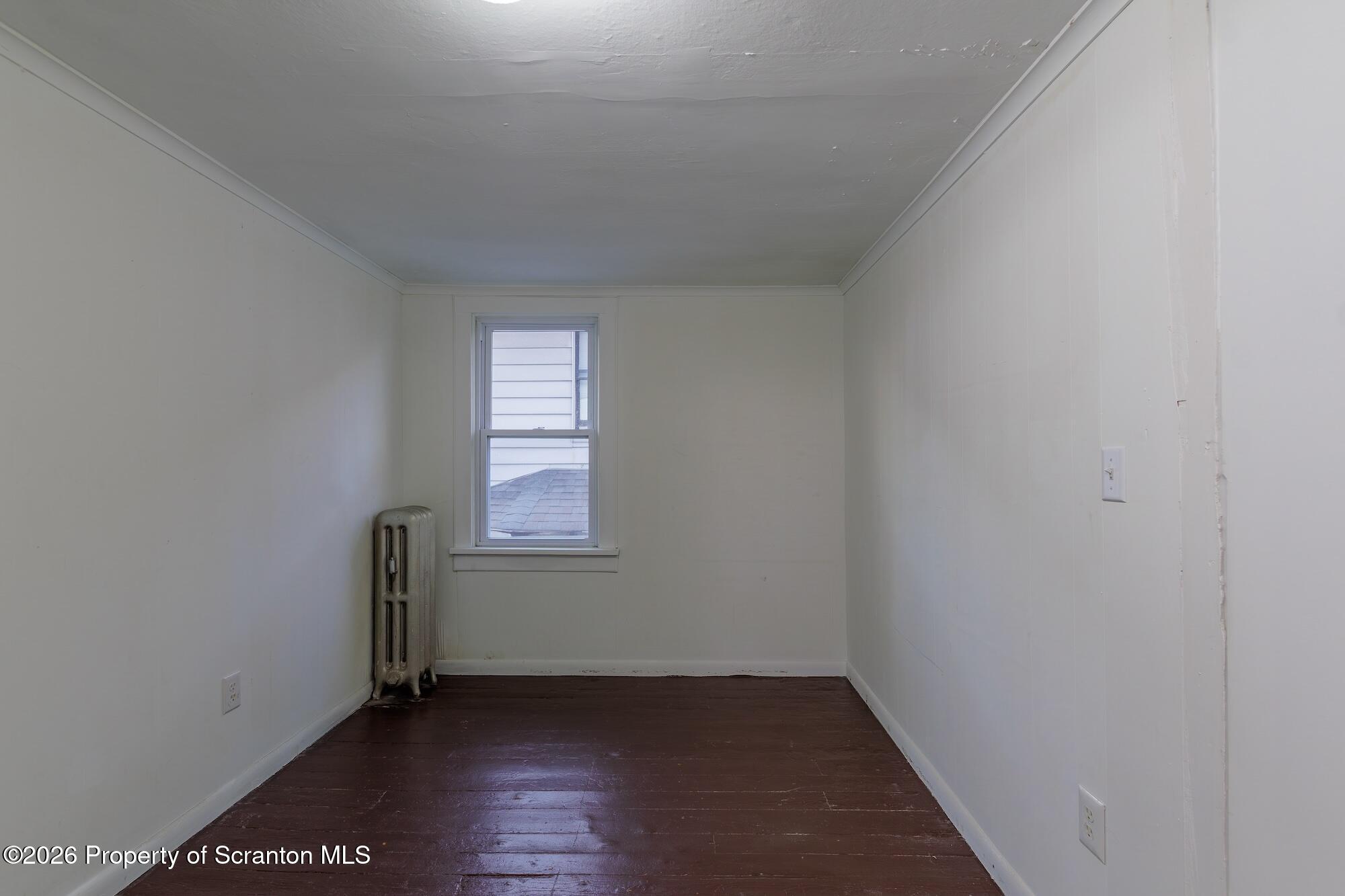 623 East Elm Street, Unit 3 Scranton, PA 18505 - Photo 8 of 18 an empty room with wooden floor and windows