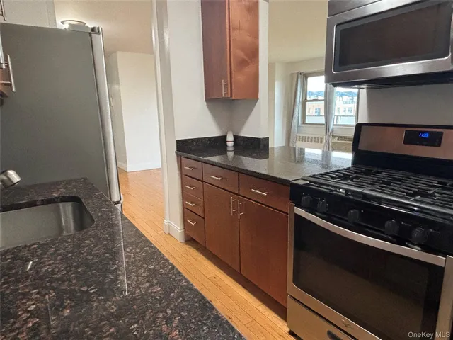 a kitchen with granite countertop a stove and a sink