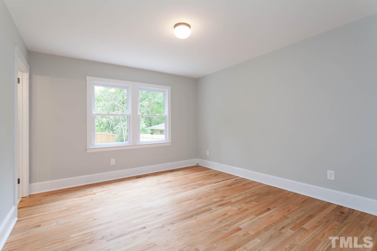 1113 Fairview Street Durham, NC 27707 - Photo 16 of 25 an empty room with wooden floor and windows