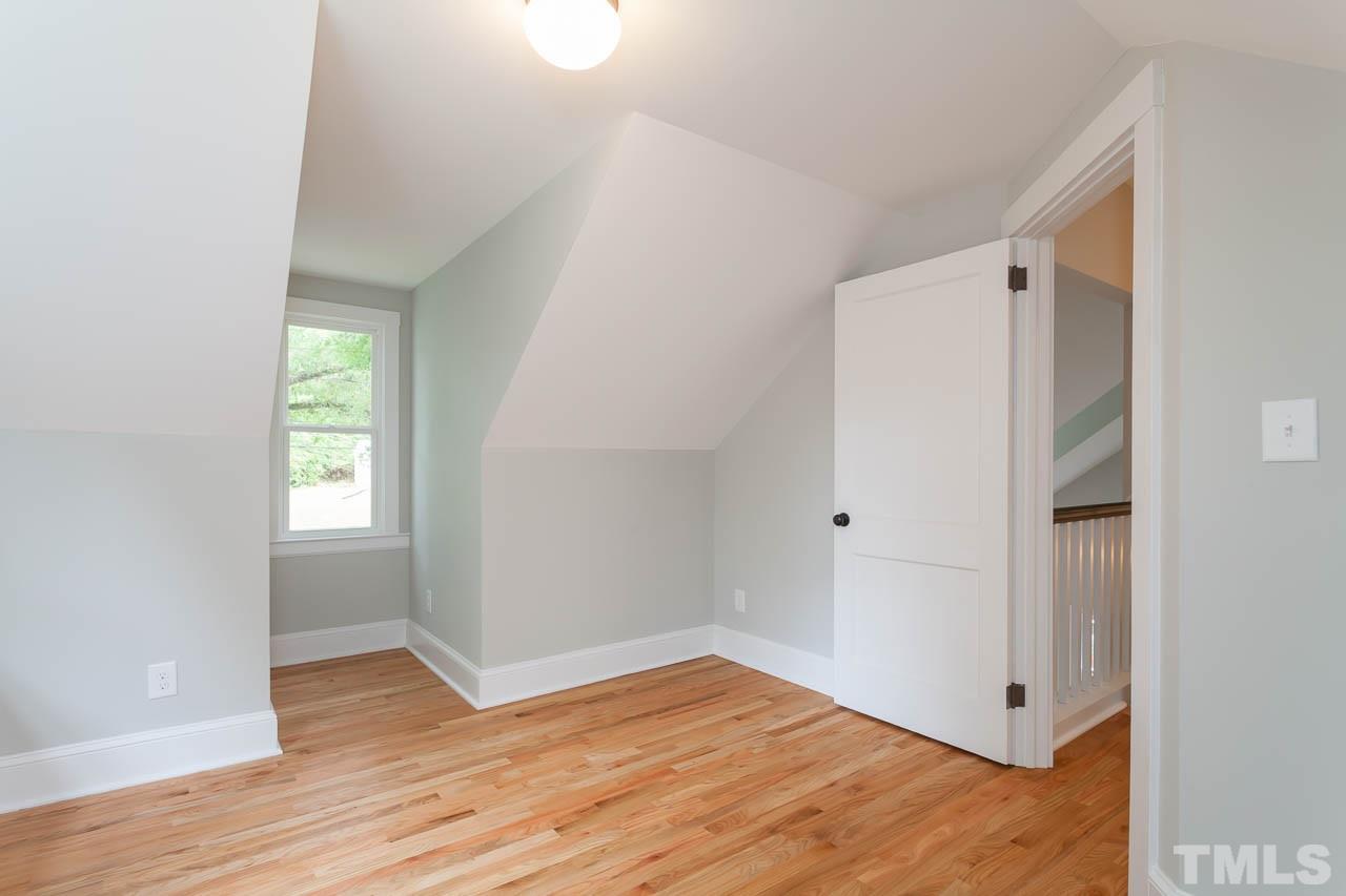 1113 Fairview Street Durham, NC 27707 - Photo 18 of 25 a view of an empty room with wooden floor and a window