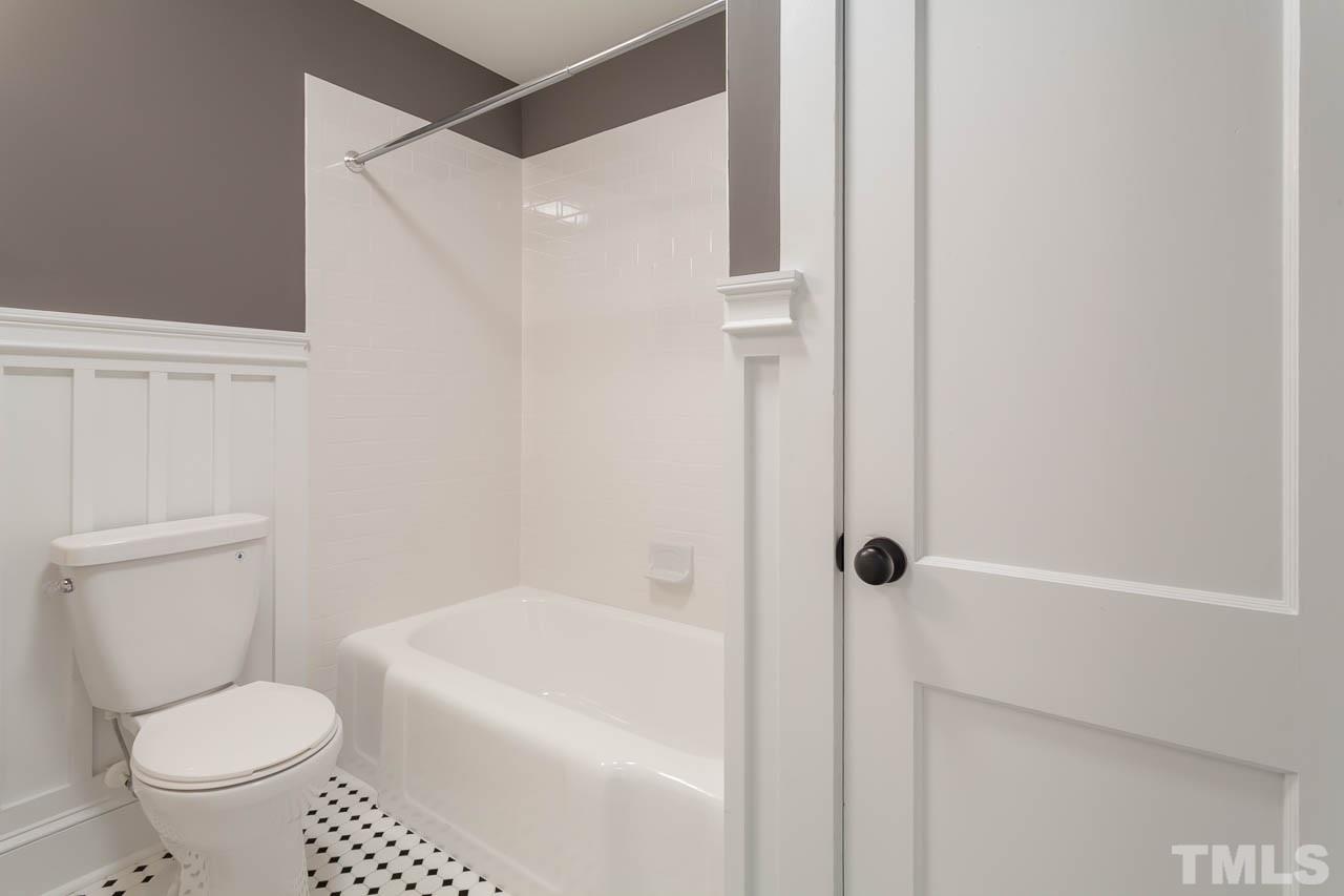 1113 Fairview Street Durham, NC 27707 - Photo 19 of 25 a white toilet sitting next to a bath tub