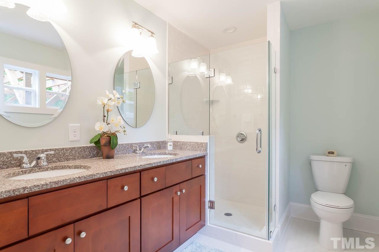 1113 Fairview Street Durham, NC 27707 - Photo 20 of 25 a bathroom with a granite countertop sink mirror and toilet
