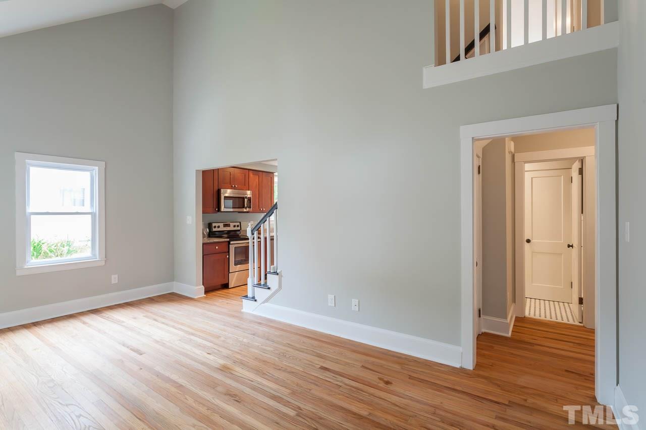 1113 Fairview Street Durham, NC 27707 - Photo 4 of 25 an empty room with wooden floor and windows