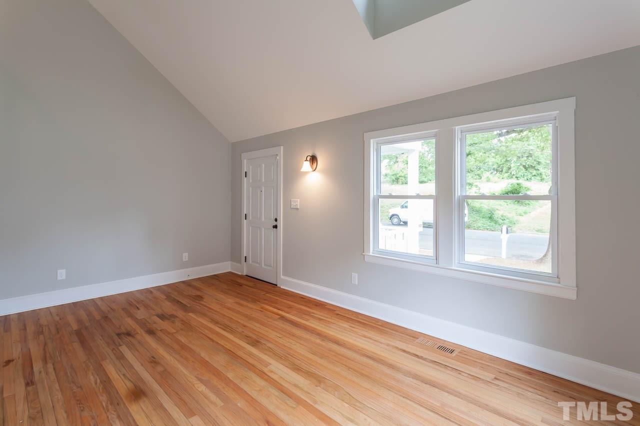 1113 Fairview Street Durham, NC 27707 - Photo 6 of 25 an empty room with wooden floor and windows