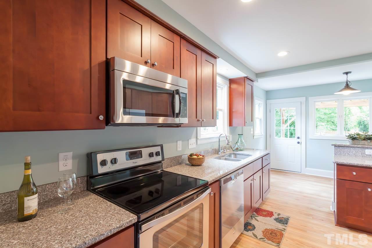 1113 Fairview Street Durham, NC 27707 - Photo 8 of 25 a kitchen with stainless steel appliances granite countertop a stove a sink and a microwave