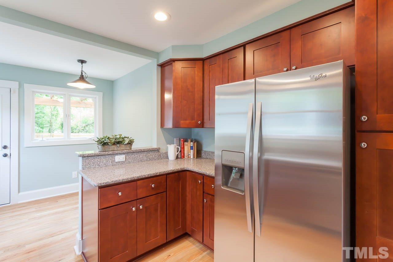 1113 Fairview Street Durham, NC 27707 - Photo 9 of 25 a kitchen with stainless steel appliances granite countertop a refrigerator and a sink