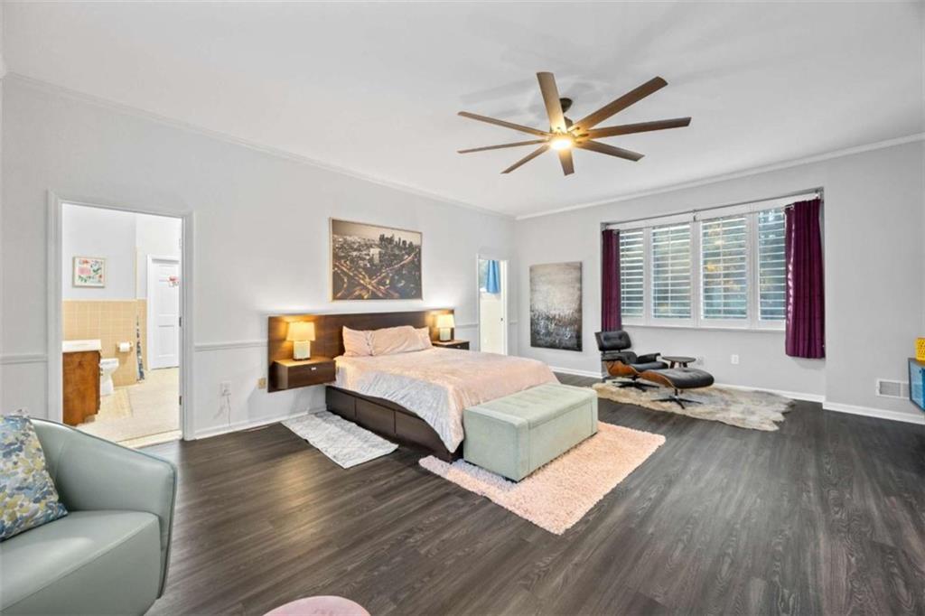 200 McGuirts Bridge Road Covington, GA 30014 - Photo 19 of 100 a spacious bedroom with a bed a couch and a window