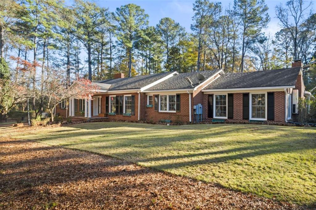 200 McGuirts Bridge Road Covington, GA 30014 - Photo 2 of 100 a front view of a house with a garden