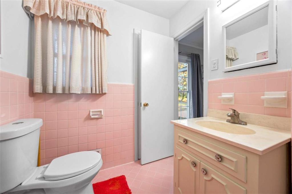 200 McGuirts Bridge Road Covington, GA 30014 - Photo 29 of 100 a bathroom with a sink a toilet and mirror