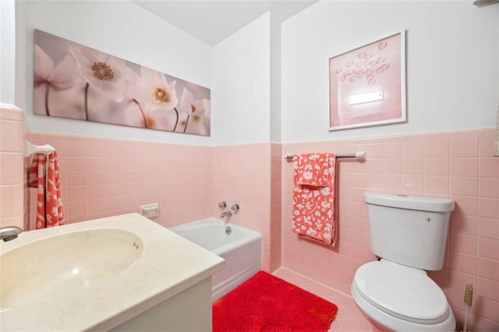 200 McGuirts Bridge Road Covington, GA 30014 - Photo 30 of 100 a white toilet sitting next to a bathroom sink