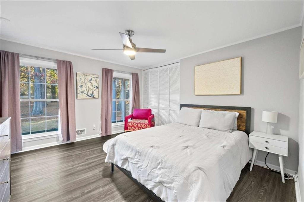 200 McGuirts Bridge Road Covington, GA 30014 - Photo 32 of 100 a spacious bedroom with a bed and wooden floor