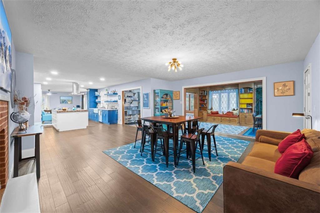 200 McGuirts Bridge Road Covington, GA 30014 - Photo 40 of 100 a living room with furniture and a dining table with wooden floor