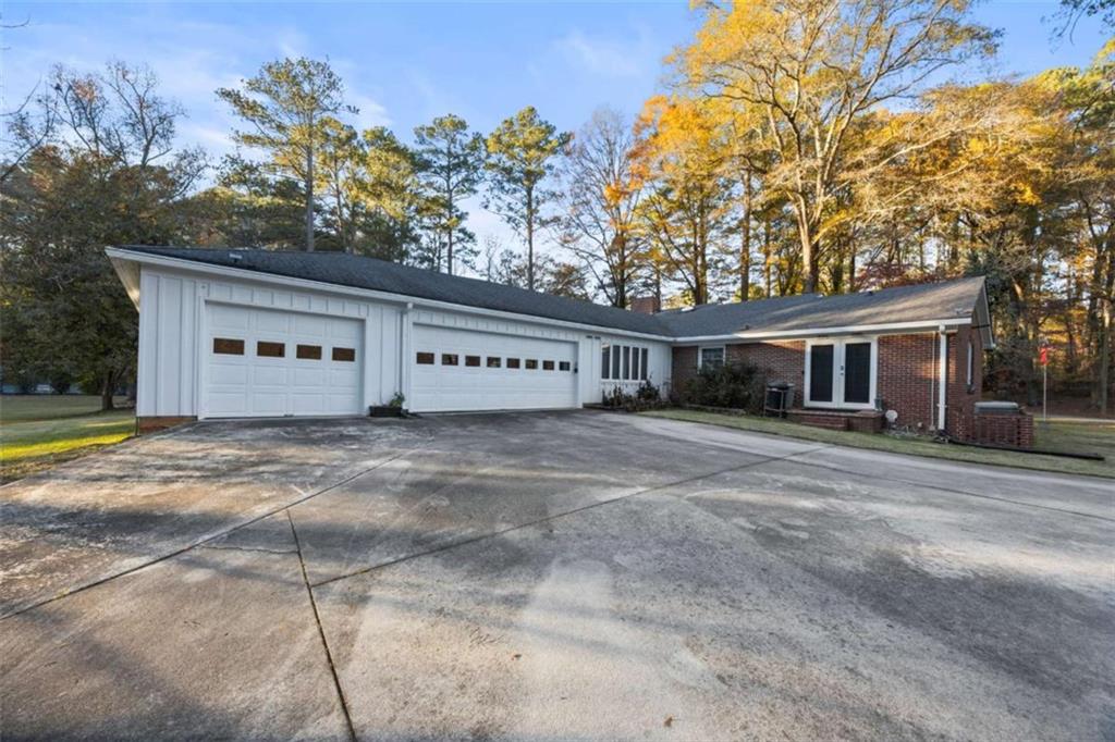 200 McGuirts Bridge Road Covington, GA 30014 - Photo 6 of 100 a front view of a house with a yard and garage