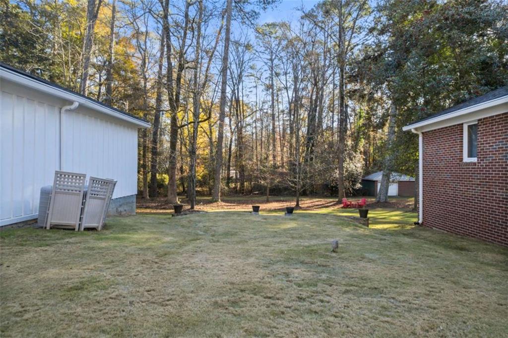 200 McGuirts Bridge Road Covington, GA 30014 - Photo 84 of 100 a view of a backyard with a sitting area and slide