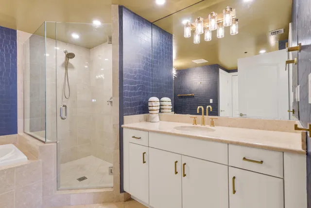 a bathroom with a sink shower and a mirror