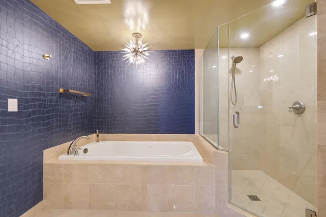 a bathroom with a bathtub and shower