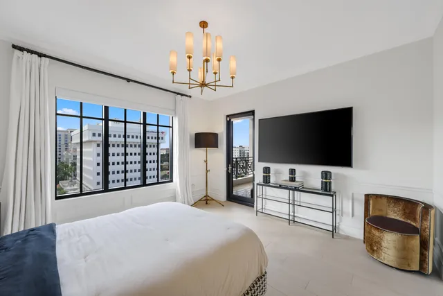 a bedroom with furniture and a flat screen tv