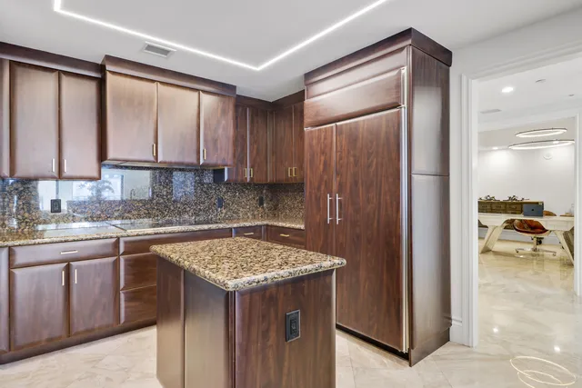 a kitchen with a sink refrigerator and cabinets