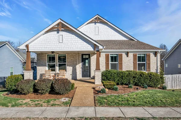 a front view of a house with a garden
