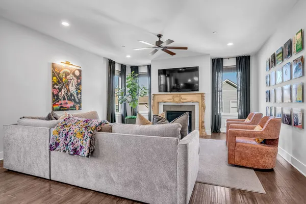 a living room with furniture fireplace and a window