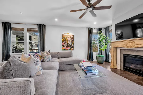 a living room with furniture a flat screen tv and a fireplace