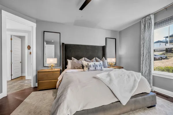 a bedroom with a bed and glass window