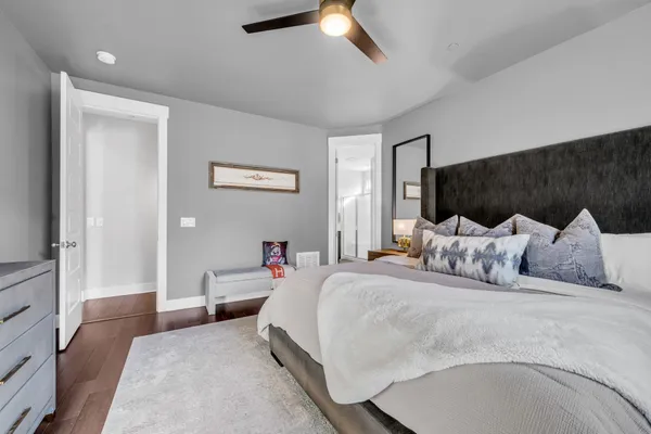 a bedroom with bed and a chandelier