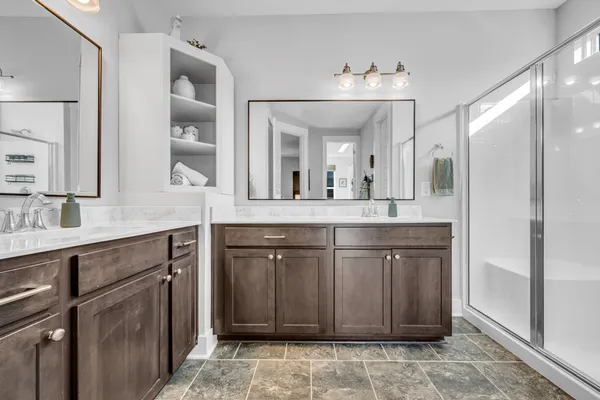 a spacious bathroom with a granite countertop sink and a mirror